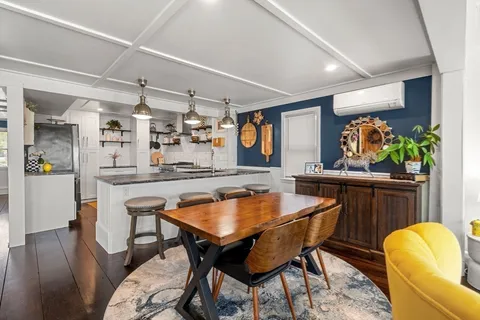 a dining room with furniture and wooden floor