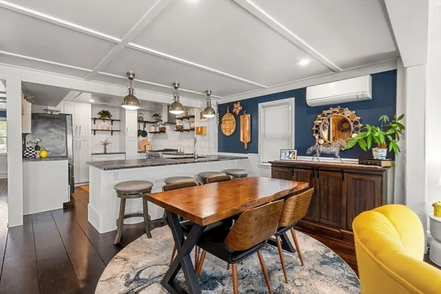 a dining room with furniture and wooden floor