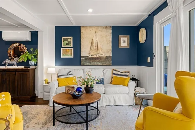 a living room with furniture and painting on the wall