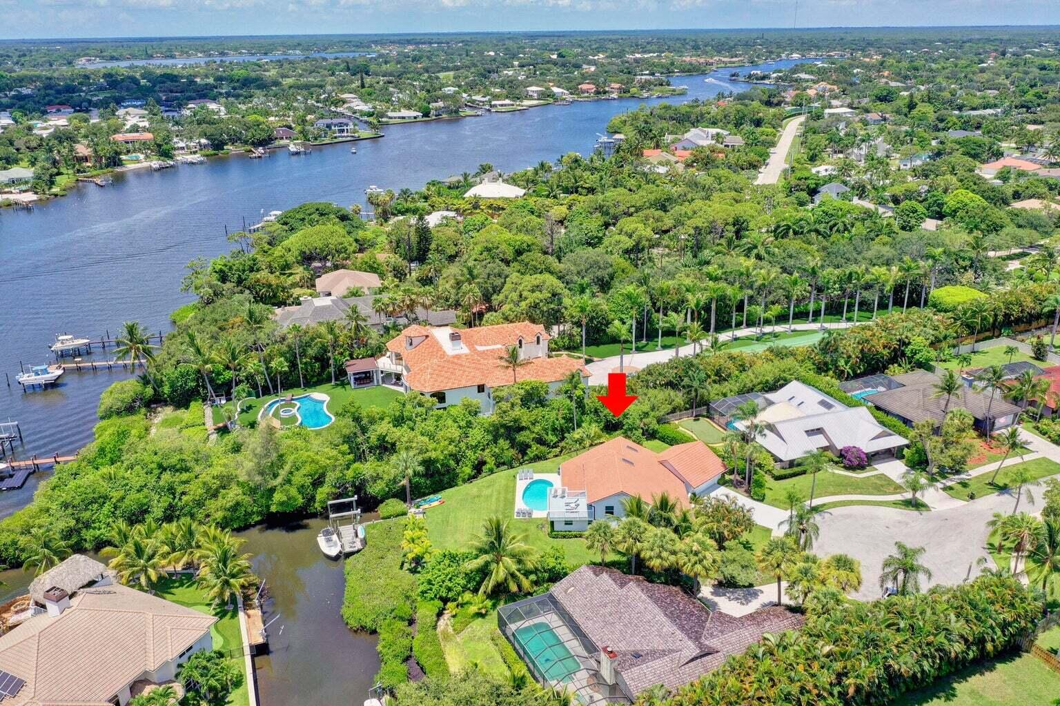 141 Pine Hill Trail West Tequesta, FL 33469 - Photo 1 of 53 an aerial view of a houses with a lake view