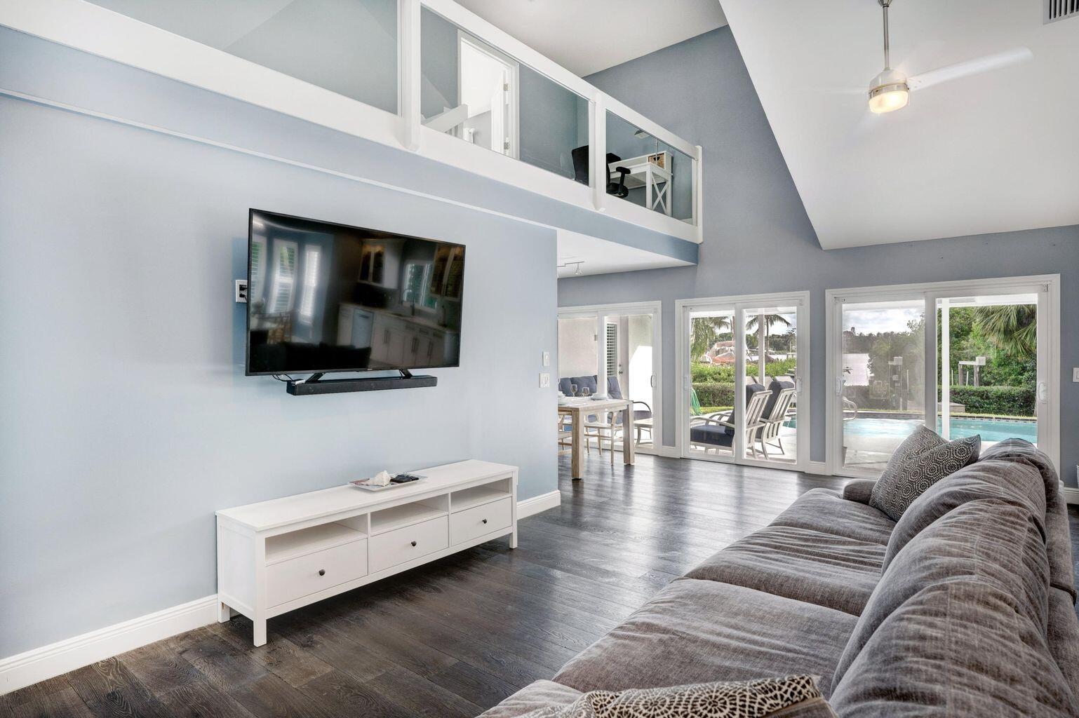 141 Pine Hill Trail West Tequesta, FL 33469 - Photo 16 of 53 a living room with furniture and a flat screen tv