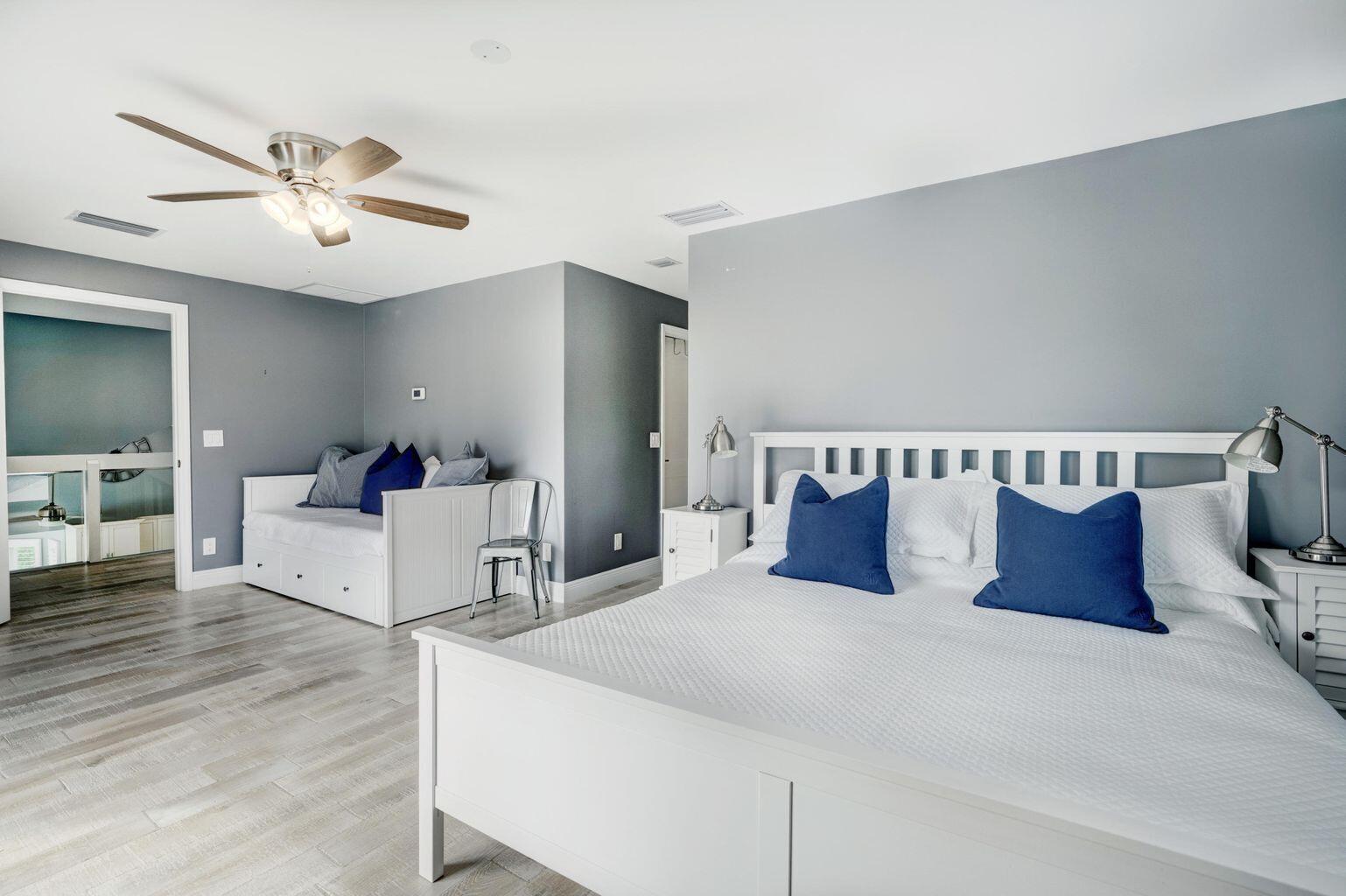 141 Pine Hill Trail West Tequesta, FL 33469 - Photo 26 of 53 a bed room with a bed and a chandelier