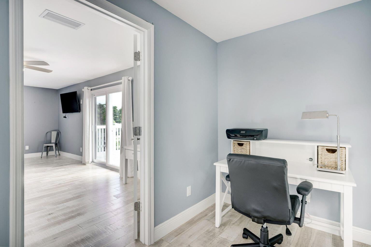 141 Pine Hill Trail West Tequesta, FL 33469 - Photo 27 of 53 a workspace with furniture and wooden floor