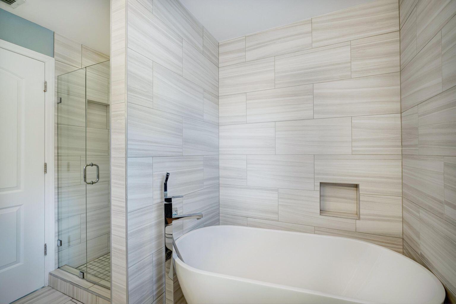 141 Pine Hill Trail West Tequesta, FL 33469 - Photo 30 of 53 a white bath tub sitting next to a shower