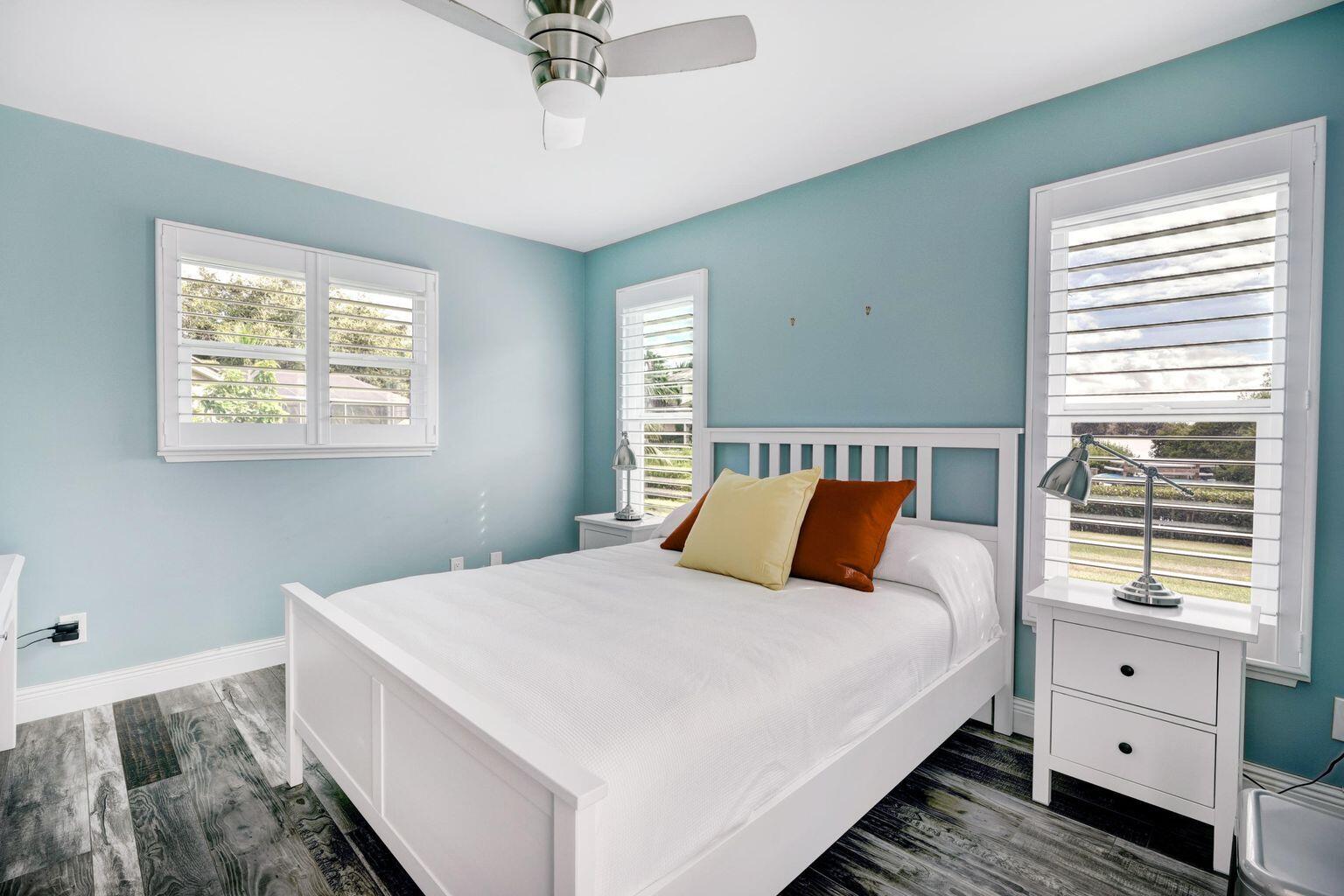 141 Pine Hill Trail West Tequesta, FL 33469 - Photo 32 of 53 a bedroom with a large bed and a window