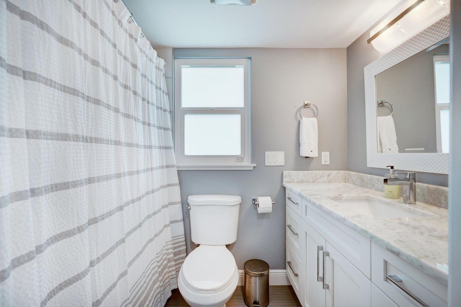 141 Pine Hill Trail West Tequesta, FL 33469 - Photo 34 of 53 a bathroom with a granite countertop toilet sink and mirror