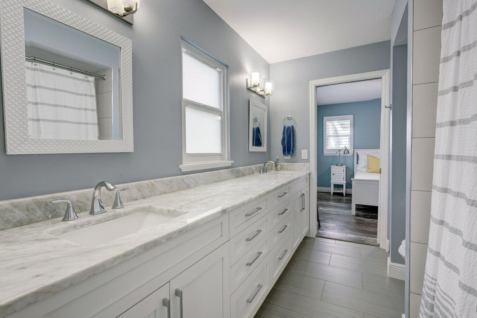 141 Pine Hill Trail West Tequesta, FL 33469 - Photo 39 of 53 a spacious bathroom with a granite countertop sink mirror and a