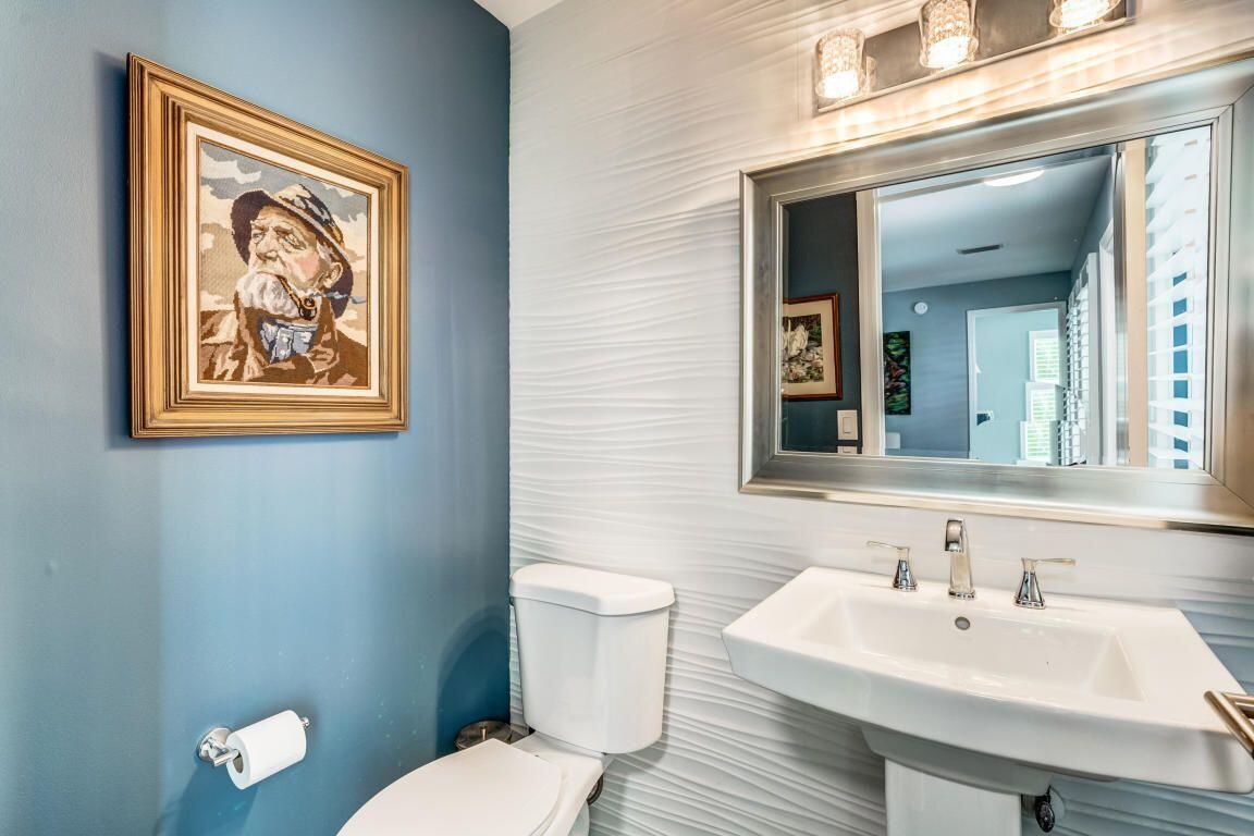 141 Pine Hill Trail West Tequesta, FL 33469 - Photo 43 of 53 a bathroom with a toilet a sink and mirror