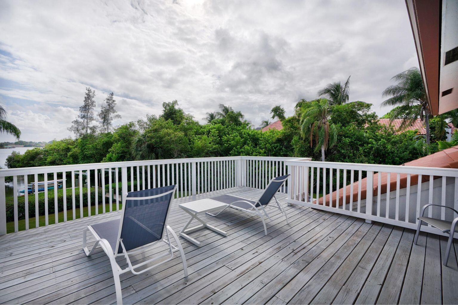 141 Pine Hill Trail West Tequesta, FL 33469 - Photo 44 of 53 a balcony with wooden floor and fence