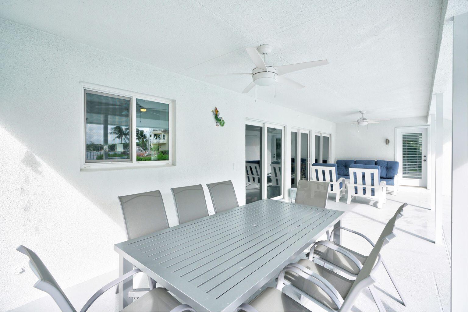 141 Pine Hill Trail West Tequesta, FL 33469 - Photo 46 of 53 a view of a dining room with furniture and wooden floor