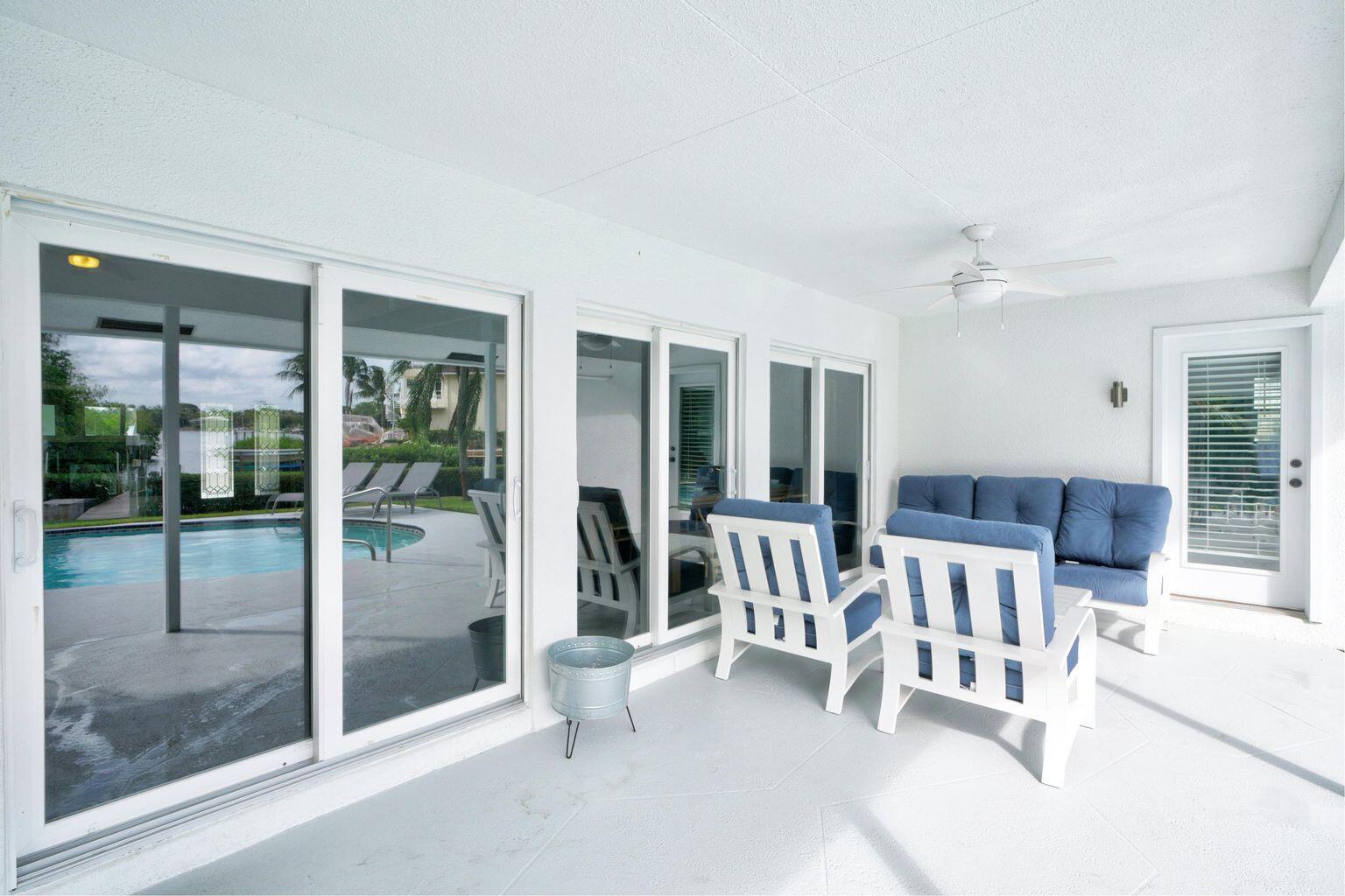141 Pine Hill Trail West Tequesta, FL 33469 - Photo 47 of 53 a view of a livingroom with furniture and floor to ceiling window
