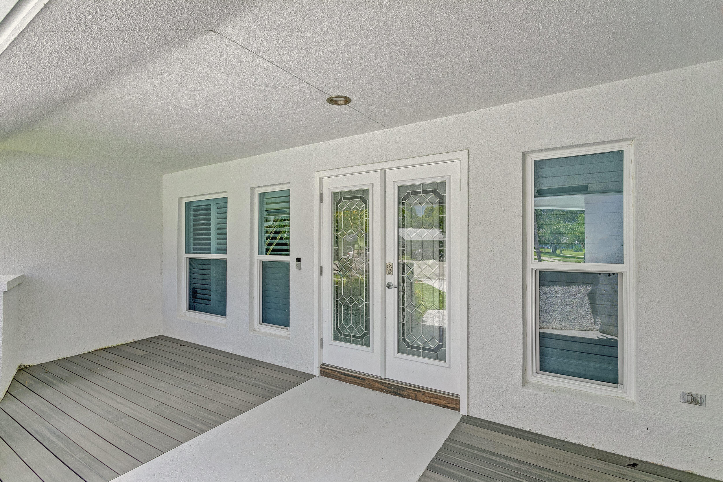 141 Pine Hill Trail West Tequesta, FL 33469 - Photo 52 of 53 a view of an empty room with wooden floor and a window