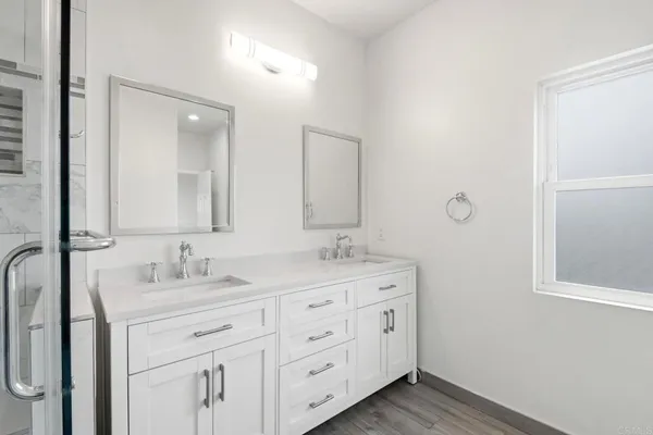 a bathroom with a double vanity sink and mirror