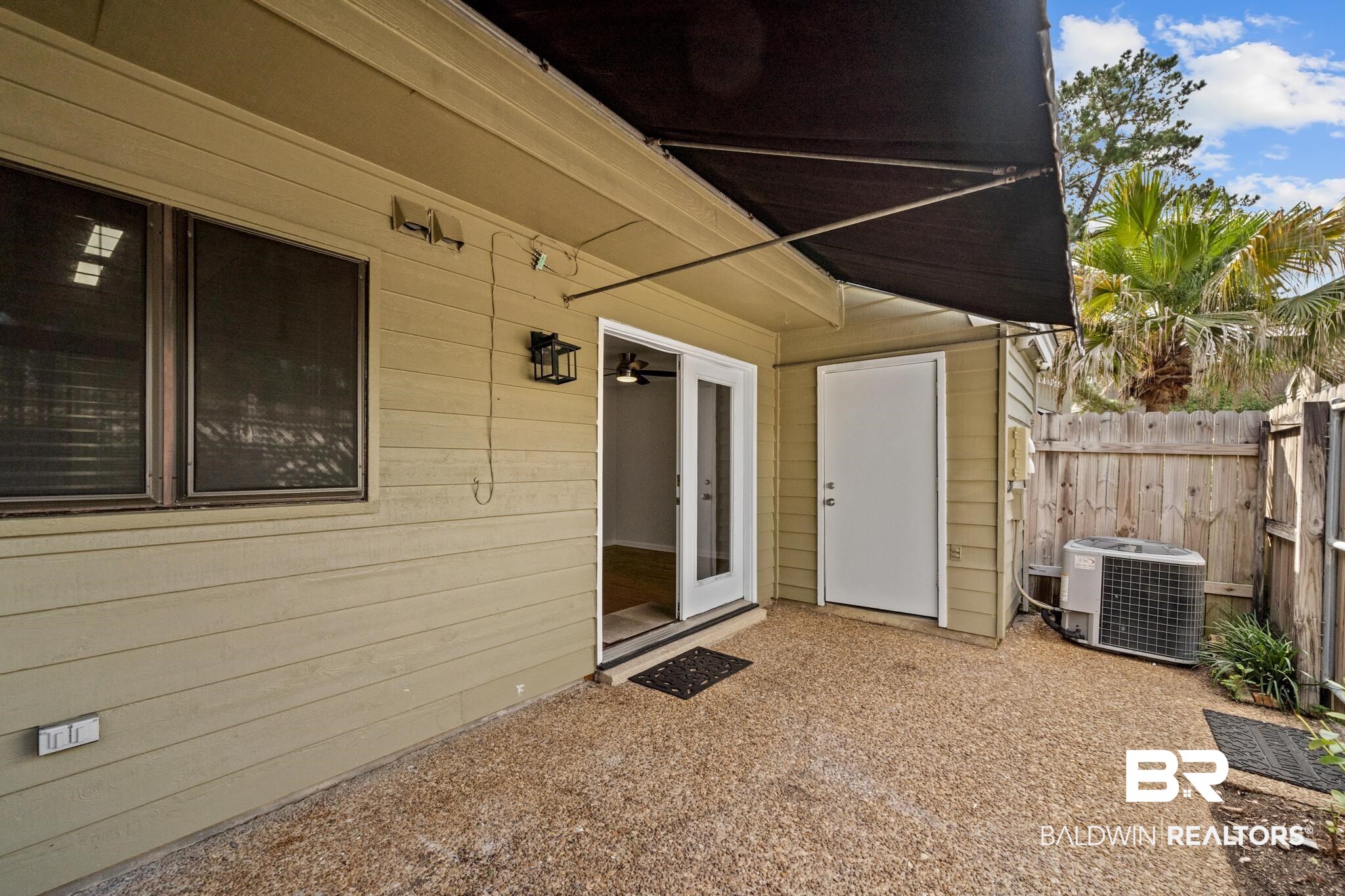 2901 Grant Street, Unit 802 Mobile, AL 36606 - Photo 31 of 37 View of exterior entry featuring central air condition unit and a patio