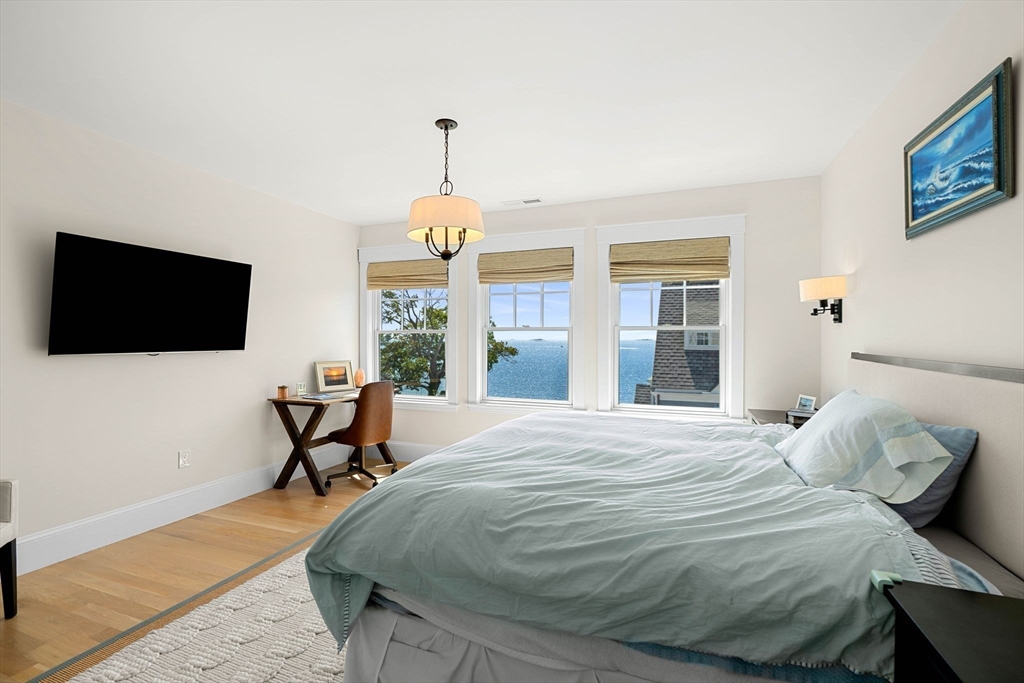 79 Lothrop Street Beverly, MA 01915 - Photo 24 of 42 a bedroom with a bed and a flat screen tv