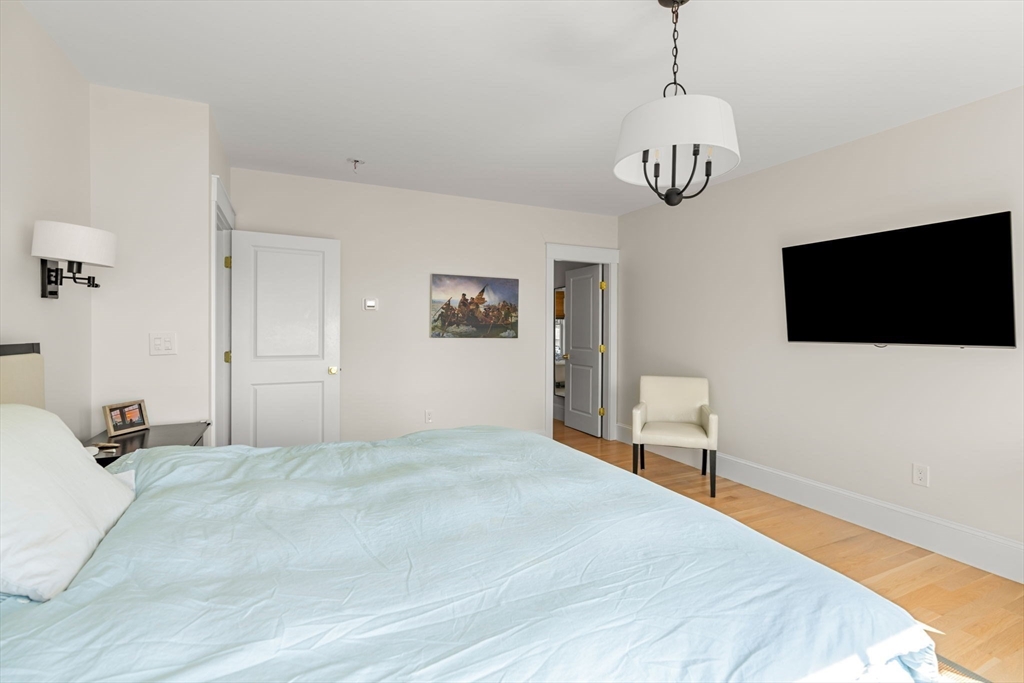 79 Lothrop Street Beverly, MA 01915 - Photo 26 of 42 a bedroom with a bed and a flat screen tv
