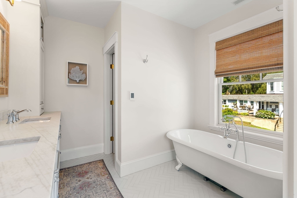 79 Lothrop Street Beverly, MA 01915 - Photo 30 of 42 a bathroom with a granite countertop tub sink and mirror