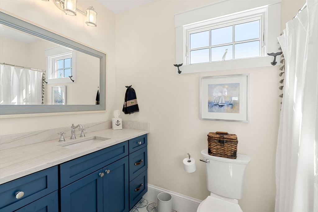 79 Lothrop Street Beverly, MA 01915 - Photo 36 of 42 a bathroom with a toilet a sink and mirror