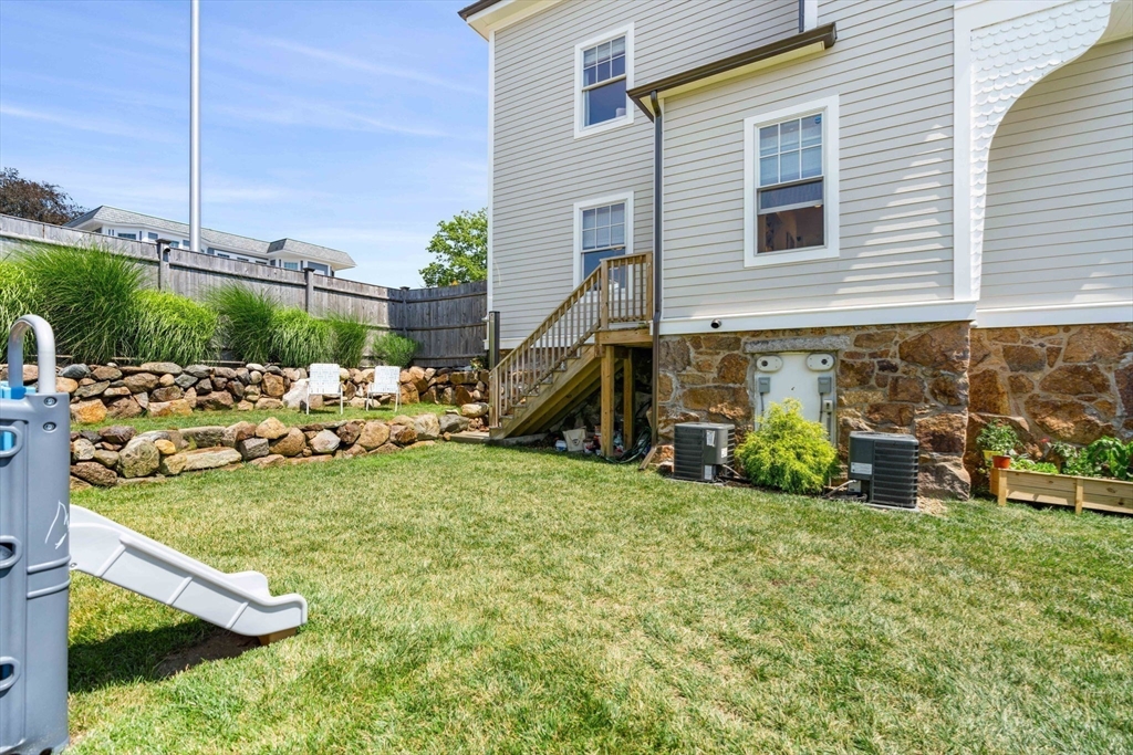 79 Lothrop Street Beverly, MA 01915 - Photo 39 of 42 a view of a backyard with sitting area and slide