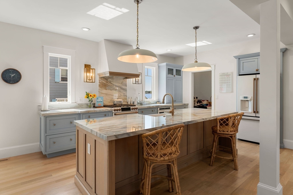 79 Lothrop Street Beverly, MA 01915 - Photo 10 of 42 a kitchen with center island table and chairs in it
