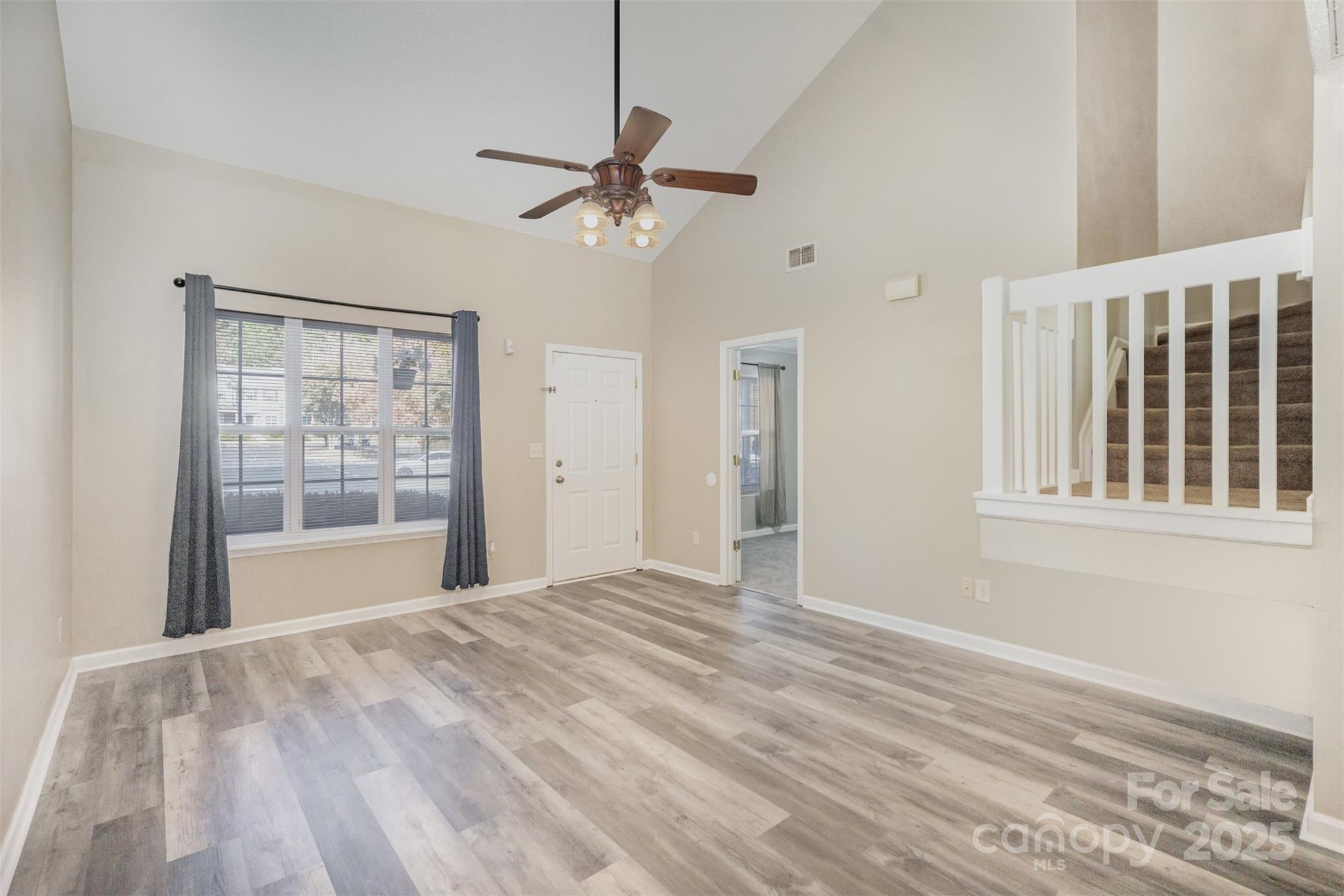 8230 Rudolph Road Charlotte, NC 28216 - Photo 14 of 38 a view of an empty room with a window and wooden floor