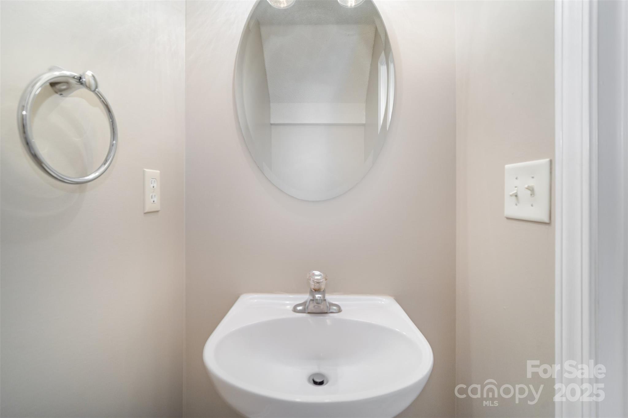 8230 Rudolph Road Charlotte, NC 28216 - Photo 23 of 38 a bathroom with a sink and mirror