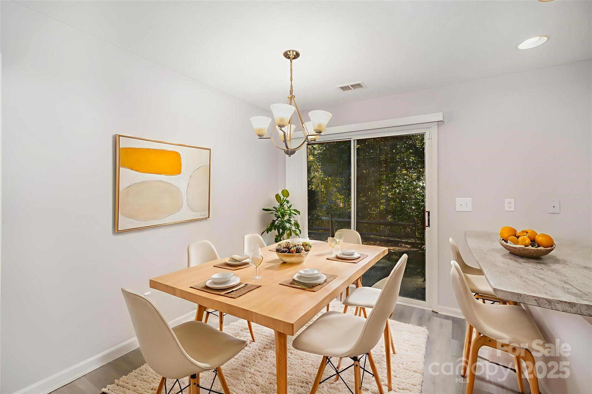 8230 Rudolph Road Charlotte, NC 28216 - Photo 3 of 38 a dining room with furniture potted plants and table
