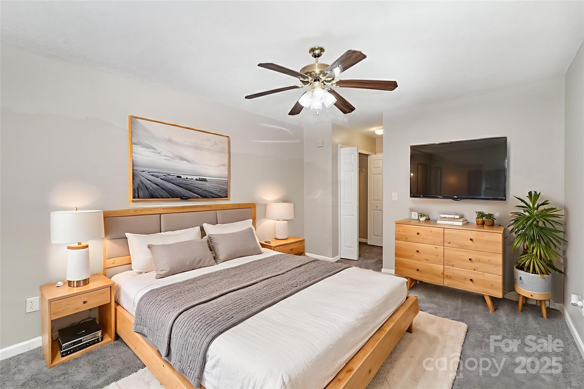 8230 Rudolph Road Charlotte, NC 28216 - Photo 5 of 38 a bedroom with a bed and flat screen tv