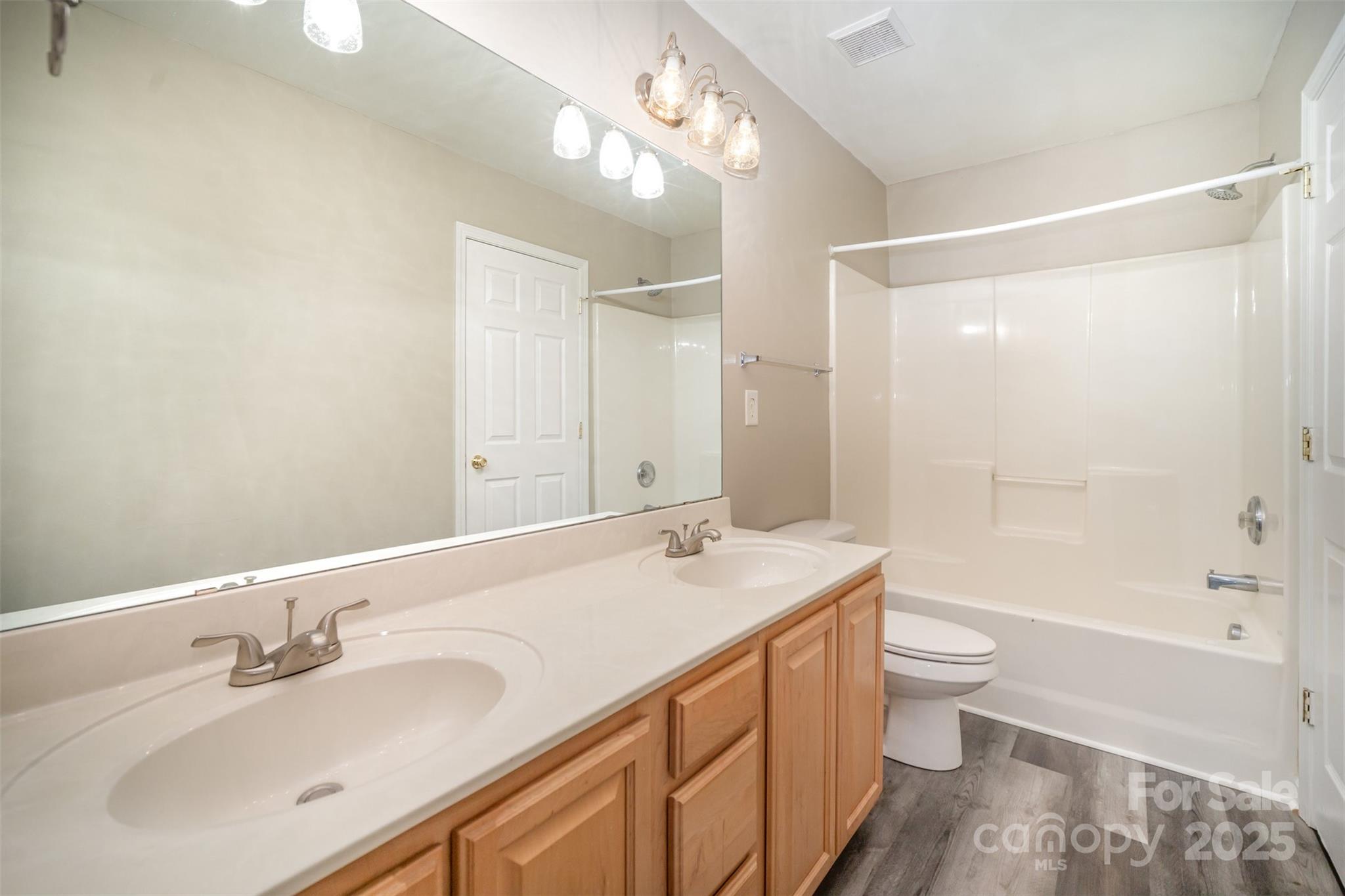 8230 Rudolph Road Charlotte, NC 28216 - Photo 6 of 38 a bathroom with a sink a toilet and shower