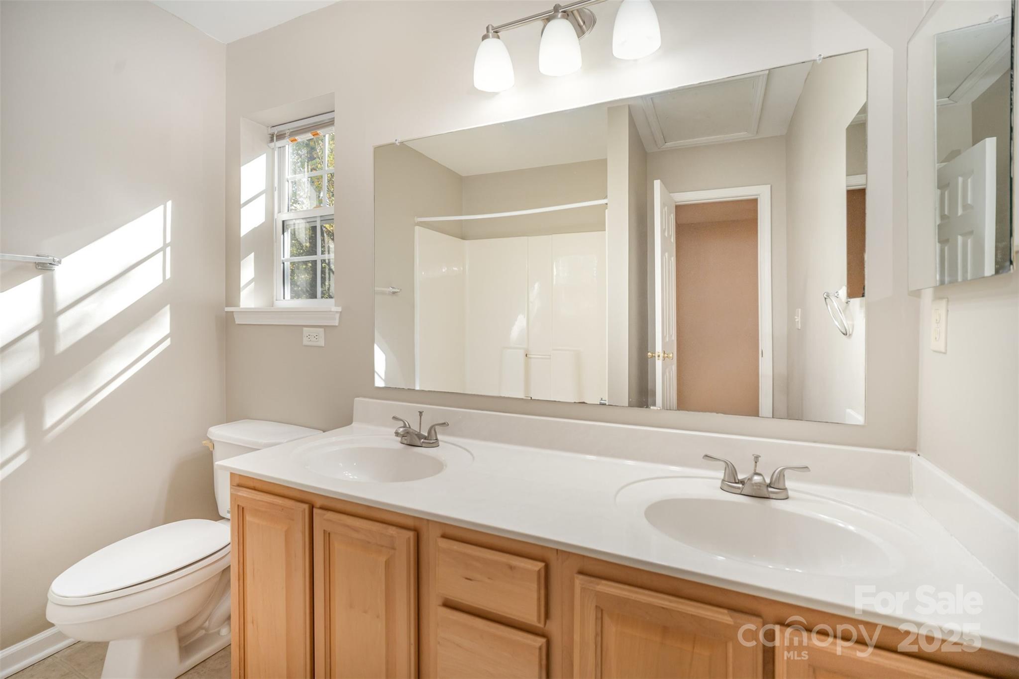 8230 Rudolph Road Charlotte, NC 28216 - Photo 8 of 38 a bathroom with a sink and a mirror