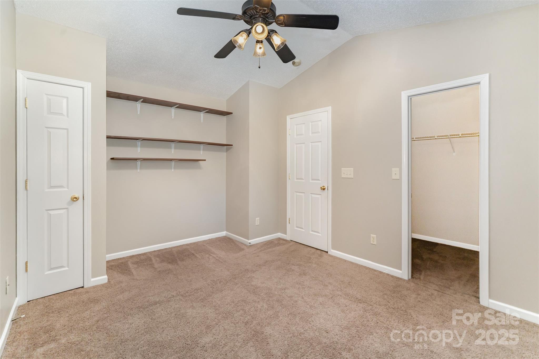 8230 Rudolph Road Charlotte, NC 28216 - Photo 9 of 38 a view of empty room with ceiling fan