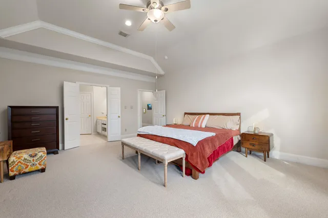 a bedroom with furniture and a chandelier