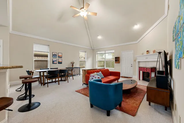 a living room with furniture a fireplace and gym equipment