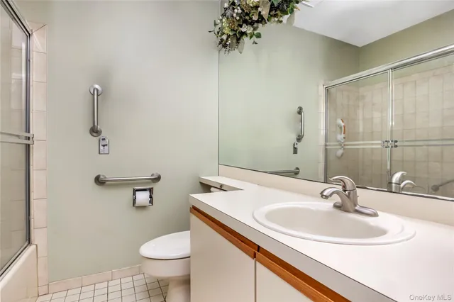 a bathroom with a sink toilet and a mirror