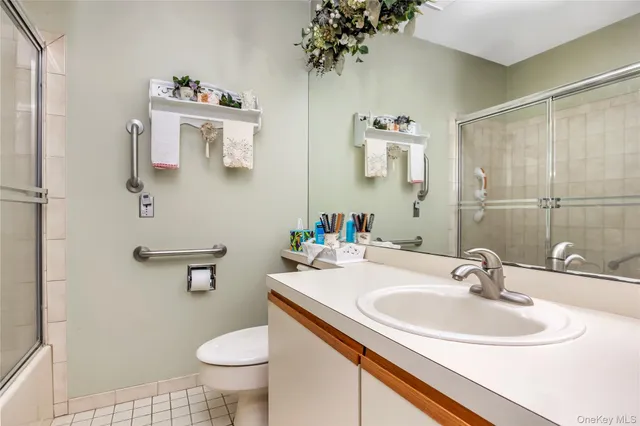 a bathroom with a sink toilet and mirror