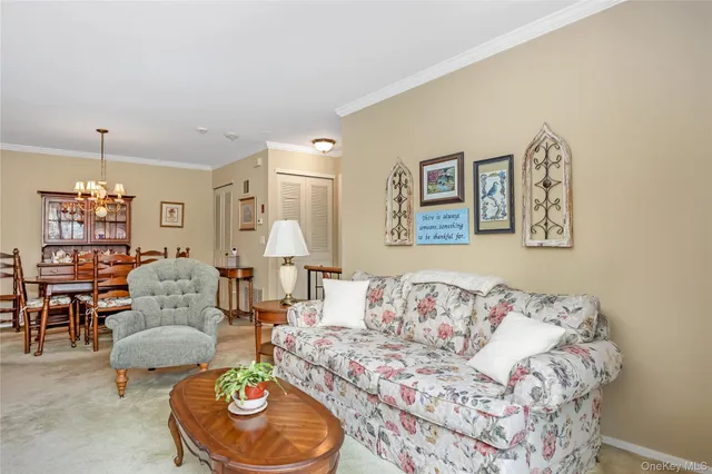 a living room with furniture and a dining table