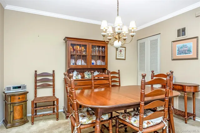 a dining room with furniture and chandelier