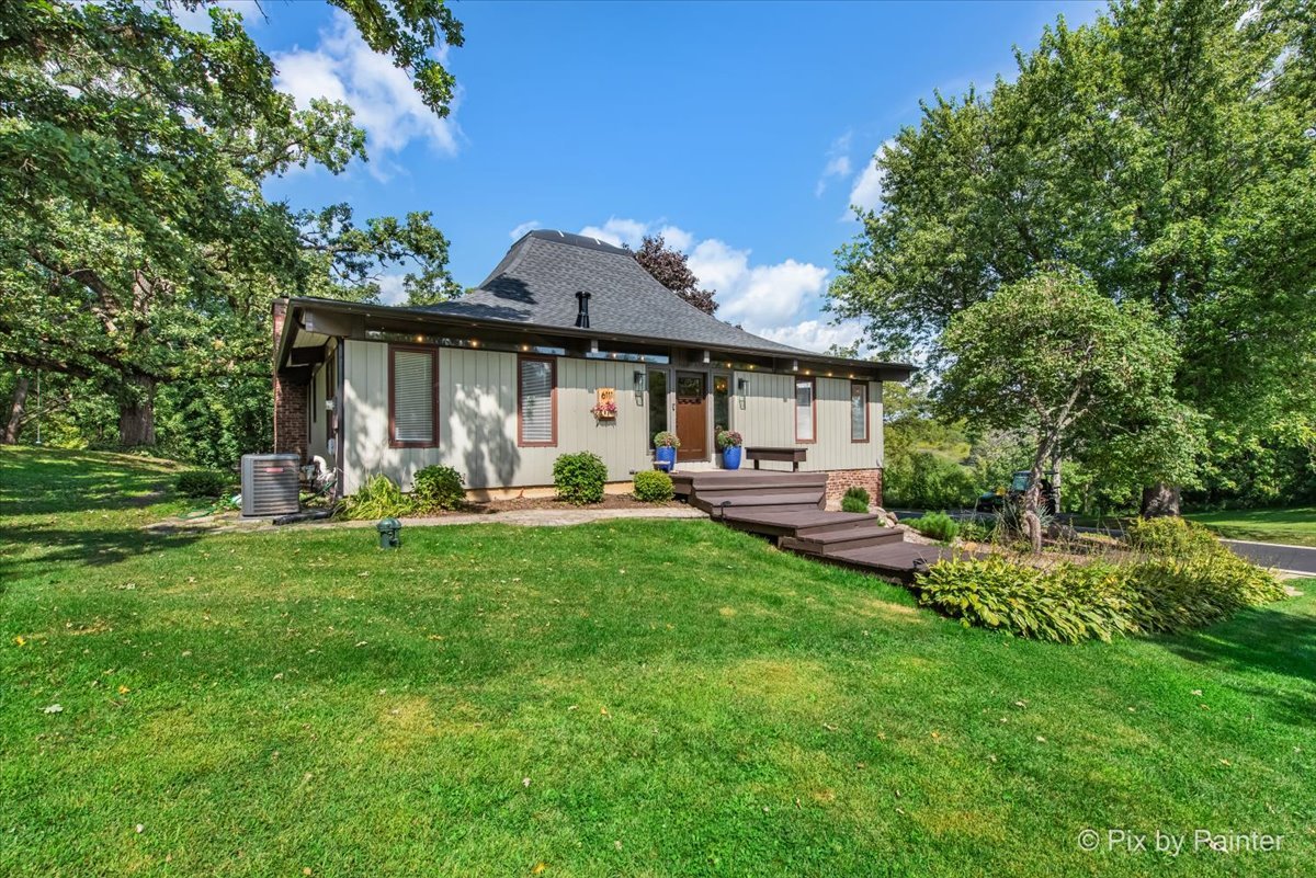 6111 Ridgeview Drive Huntley, IL 60142 - Photo 1 of 54 a front view of a house with garden and trees