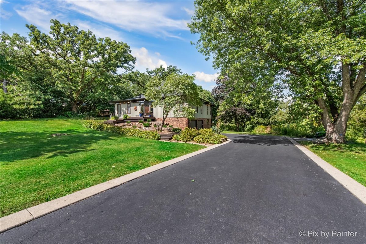 6111 Ridgeview Drive Huntley, IL 60142 - Photo 33 of 54 a view of a garden with a building in the background