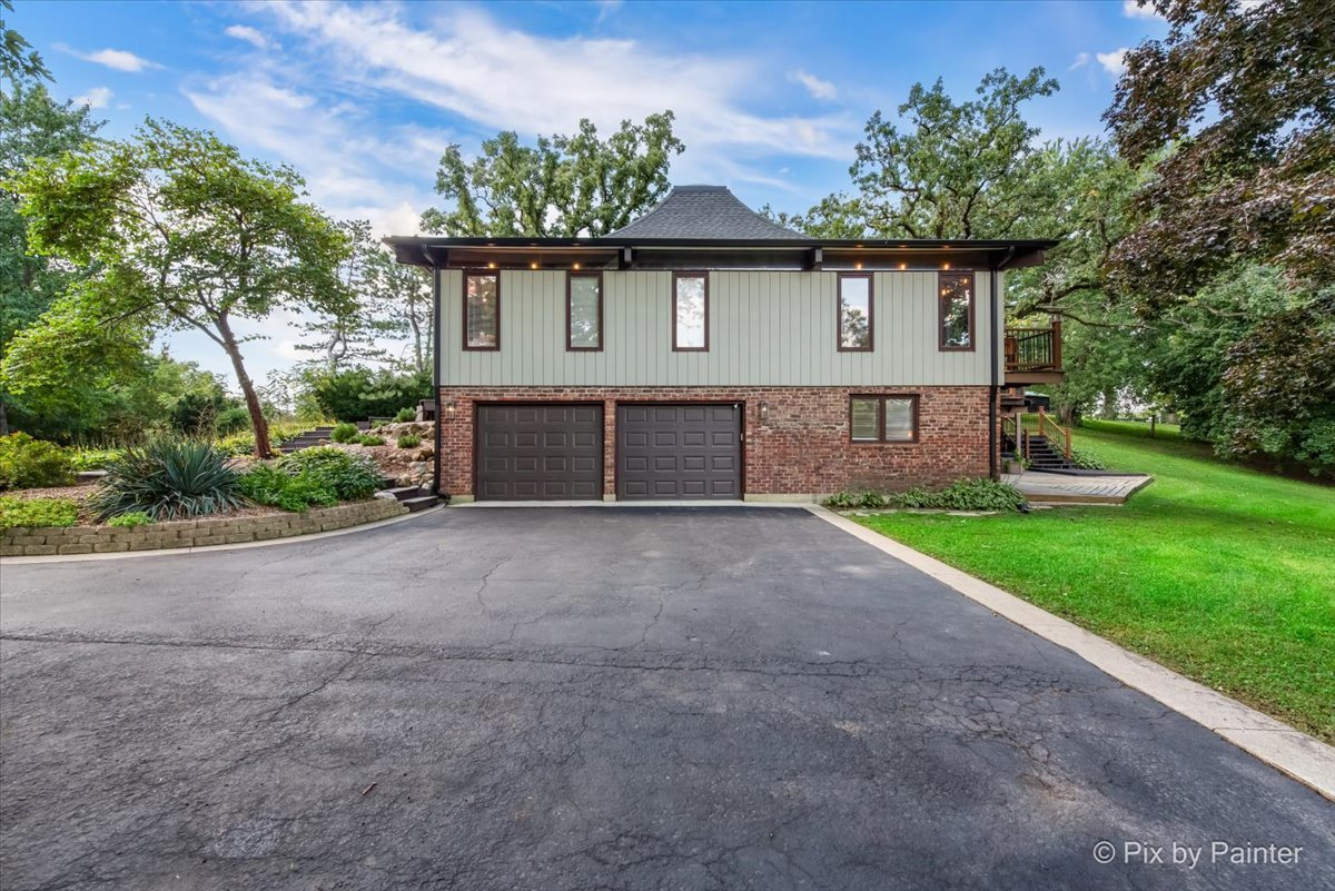 6111 Ridgeview Drive Huntley, IL 60142 - Photo 35 of 54 a front view of a house with garden