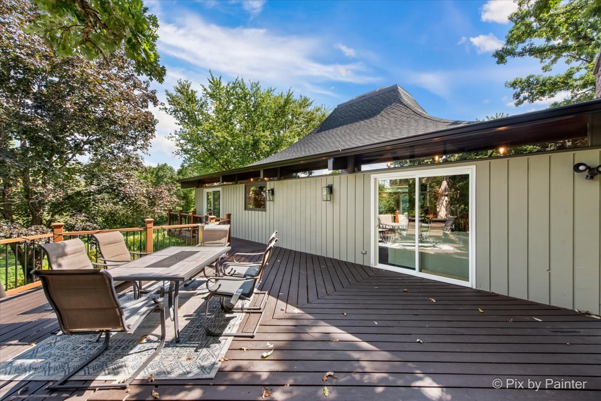 6111 Ridgeview Drive Huntley, IL 60142 - Photo 39 of 54 a view of a patio with table and chairs with wooden floor and fence