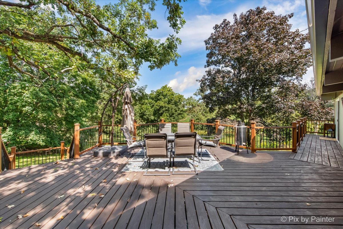 6111 Ridgeview Drive Huntley, IL 60142 - Photo 40 of 54 a view of a patio with table and chairs and wooden floor