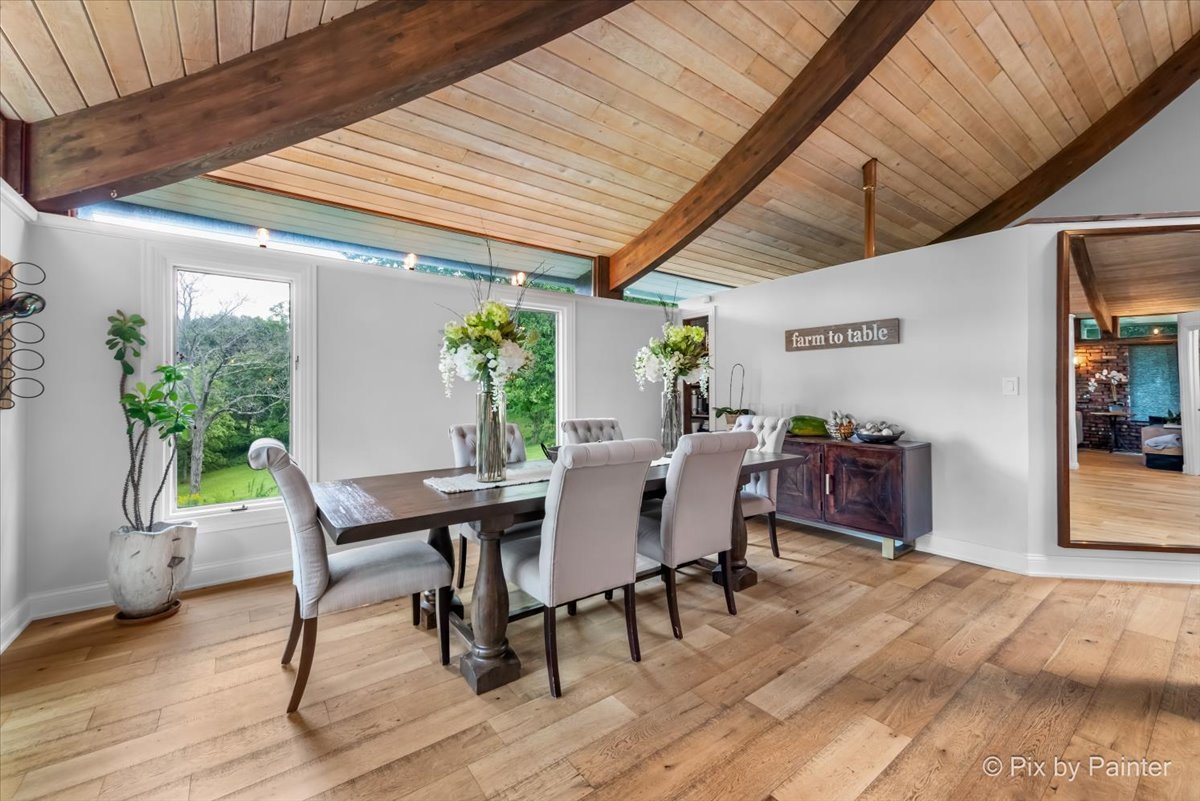 6111 Ridgeview Drive Huntley, IL 60142 - Photo 10 of 54 a view of a dining room with furniture and wooden floor