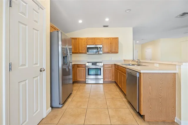 a kitchen with stainless steel appliances granite countertop a stove top oven and sink