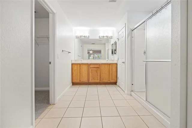 a view of a kitchen with white cabinets and refrigerator