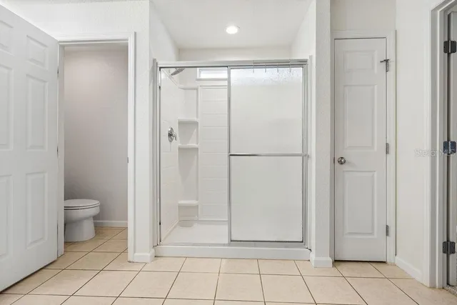 a bathroom with a shower and a toilet
