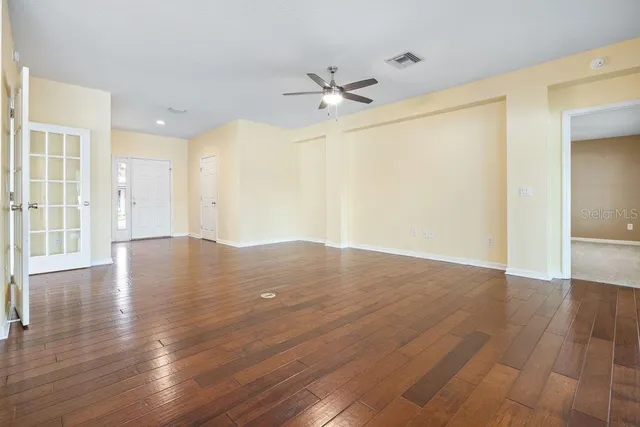 wooden floor in an empty room with a window