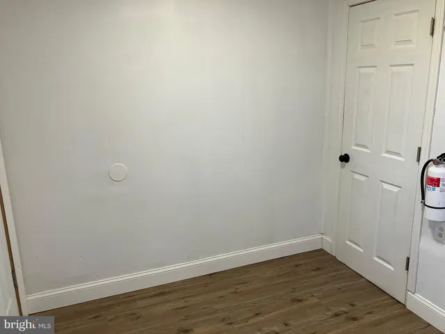 a view of a small space with wooden floor and a window