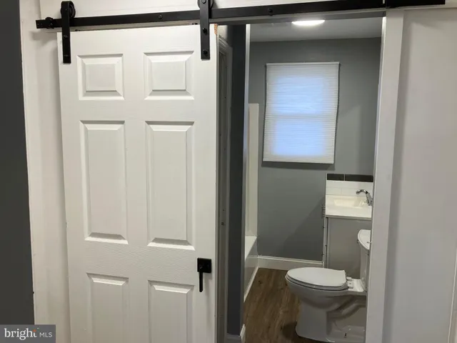 a white toilet sitting next to a bathroom sink