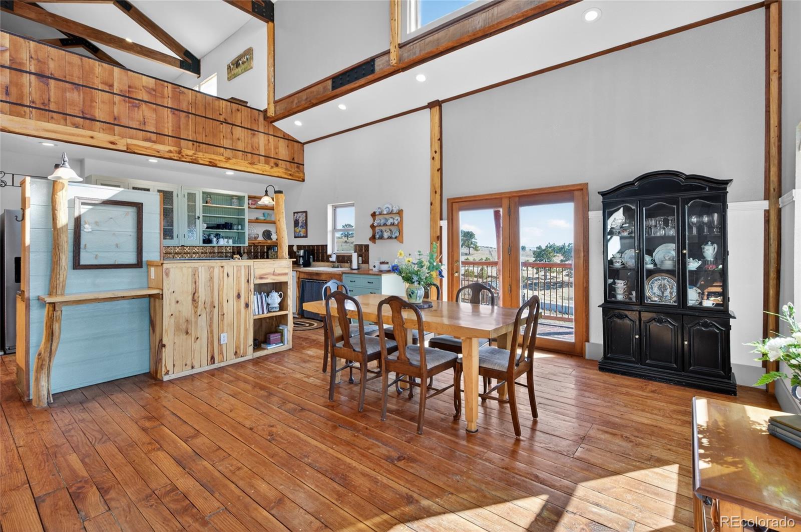 31885 Ridge Road Ramah, CO 80832 - Photo 12 of 47 a view of a dining room with furniture window and wooden floor